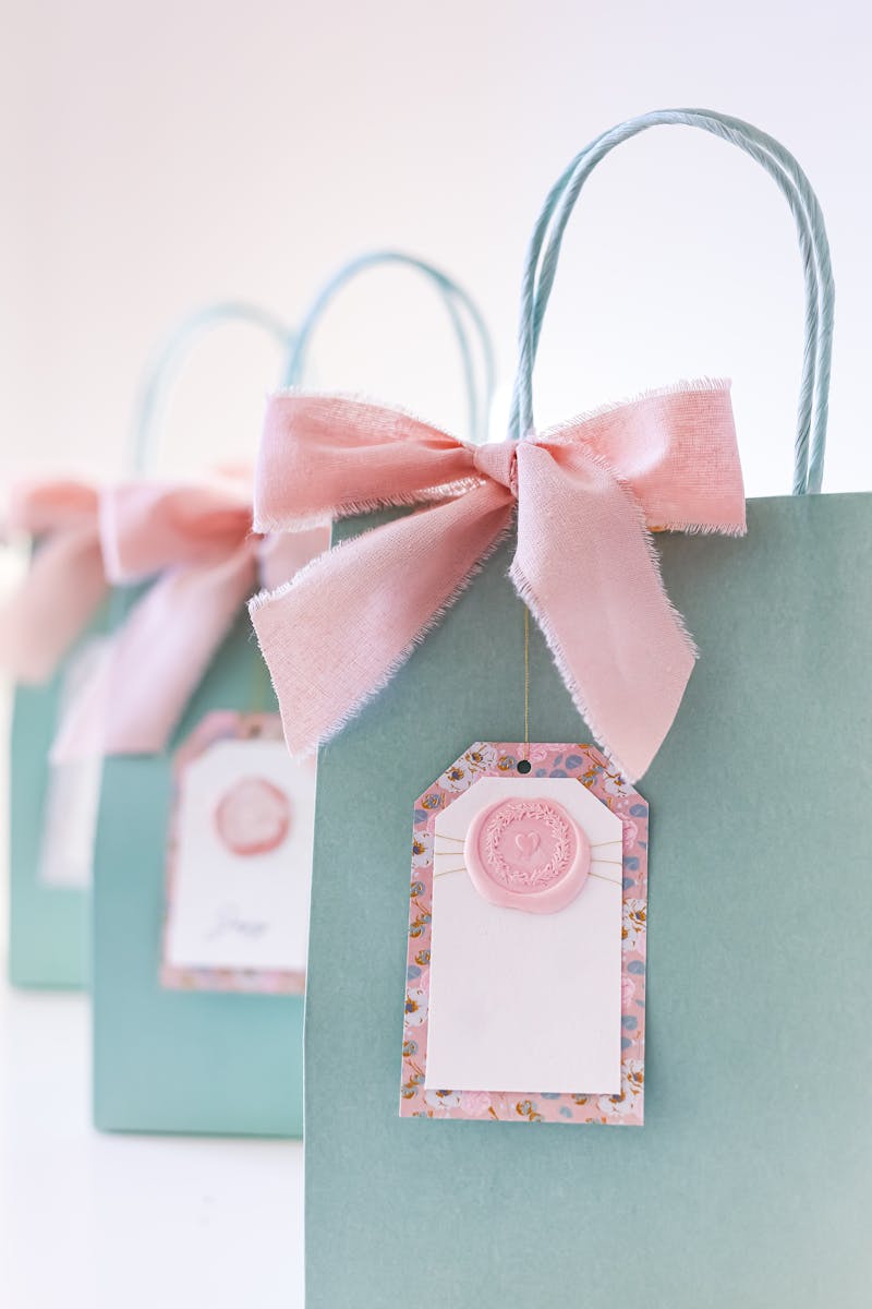 Chic gift bags adorned with pink bows, perfect for celebrations or parties.